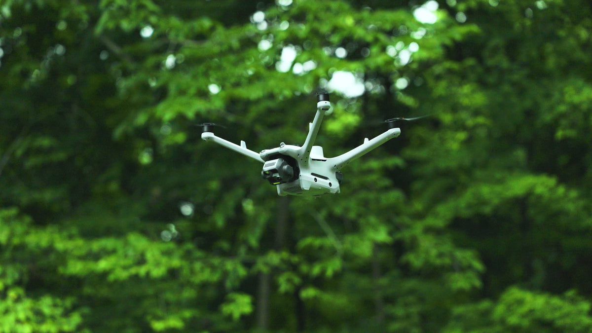 DJI Matrice 4TD flying over woodland